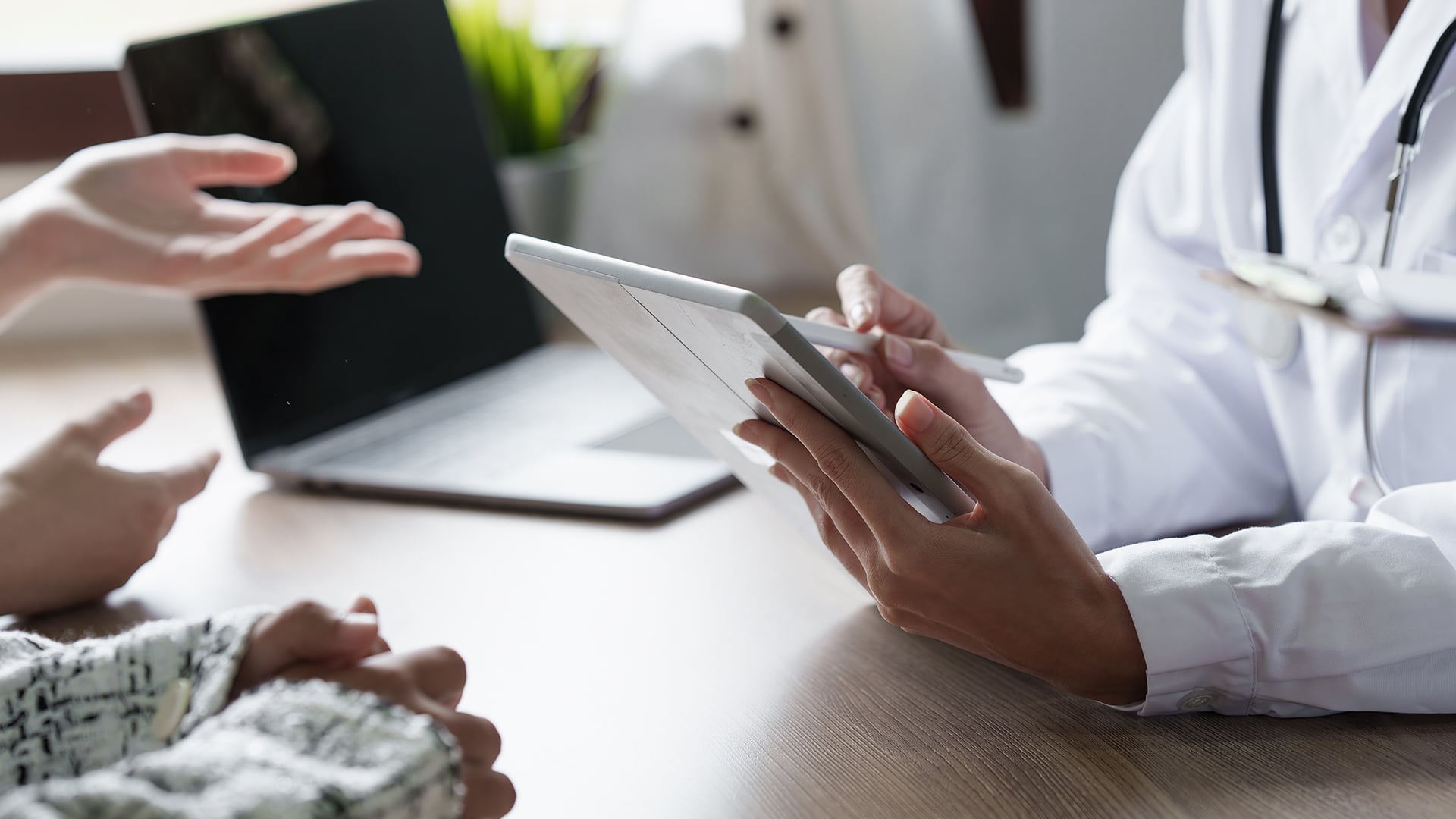 Doctor using Microsoft Copilot for healthcare to spend more time with a patient