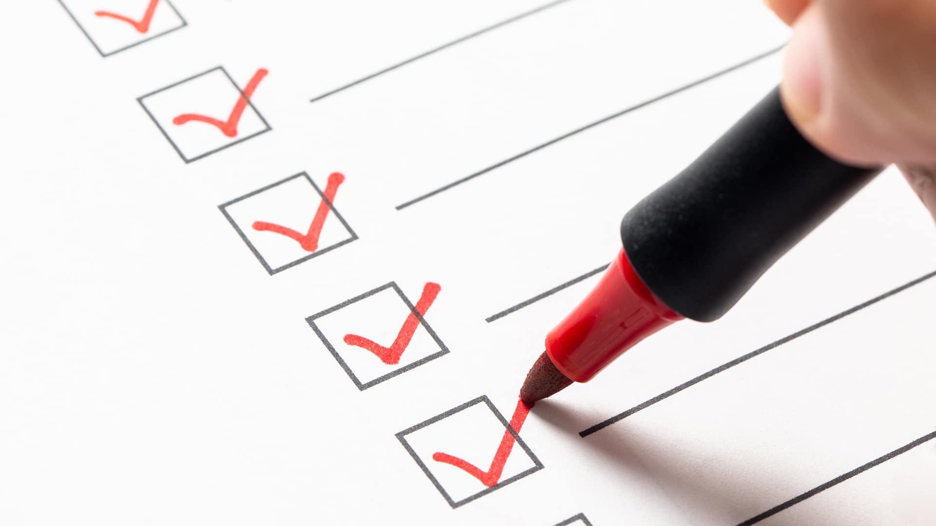 Checklist with red marker symbolizing Microsoft 365 migration planning